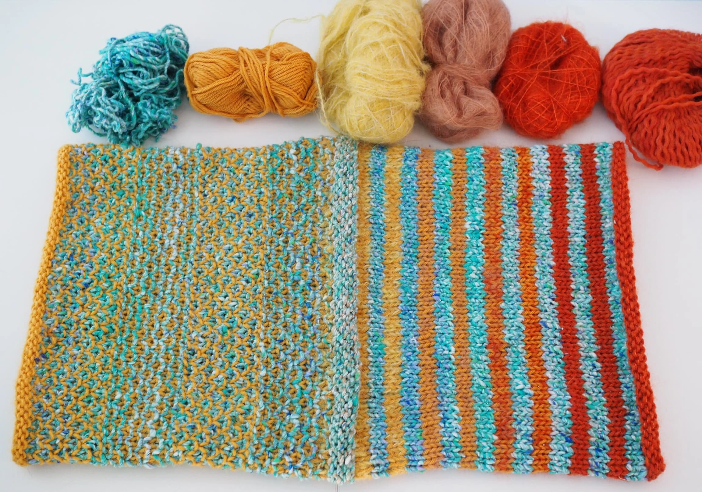 Figure 1: Left to right: Broken seed stitch, CC + MC-a (yellow, all used up so no remaining yarn shows here) and partially MC-b (light yellow) /n 1st/2nd stripe: MC-b (light yellow), 3rd/4th stripe: MC-c (yellow-orange), 5th/6th stripes: MC-d (orange), 7th/8th stripes: MC-e (red)